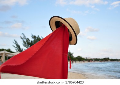 Red Flag On The Seashore - A Sign Of A Troubled Sea And A Possible Storm