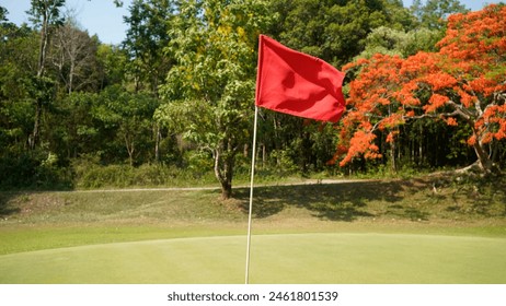 Red flag with a place to write. Countryside golf course with flag, greens and hills. Golf course in the countryside                                - Powered by Shutterstock