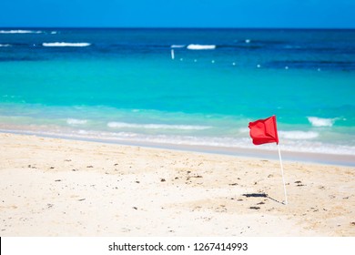 Red Flag warning sign at the beack no swimming waves