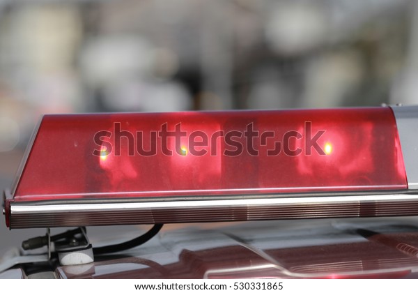 Red flashing
sirens of police car during
driving