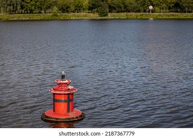 red floating lighthouse on the surface of the water. High quality photo