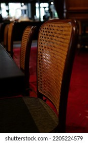 Red Floor Tiles And Vintage Rattan Chairs