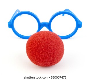 Red foam clown nose with blue plastic toy glasses. Silly, goofy, funny. 
