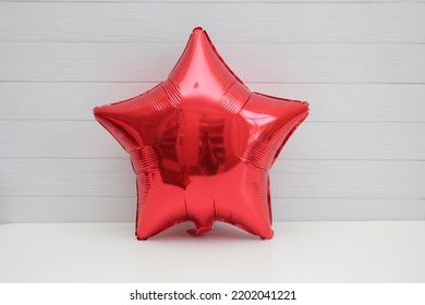 Red Foil Balloon Star On White Background
