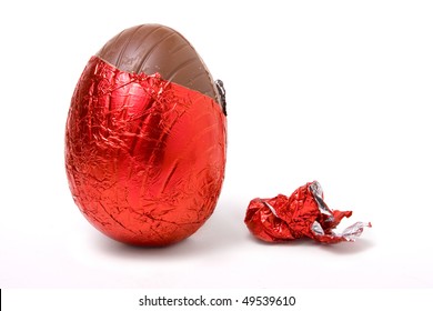 Red Foil Wrapped Chocolate Easter Egg Isolated Against White Background