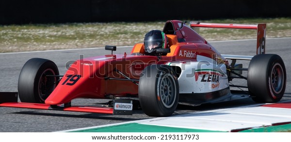 Red\
formula racing car close up action on motor sport racetrack.\
Mugello, Italy, march 25 2022. 24 Hours\
series