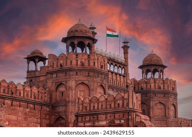 Red Fort or Lal Qila in Delhi with indian flag on foreground with moody sk.UNESCO World heritage site. Discover the India. Open world after covid-19 - Powered by Shutterstock