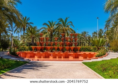 Red fountain inside of El Palmeral municipal park in Elche, Spain