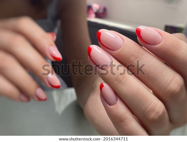 red French nails polishing nails with gel polish,\
manicure on hands, neat hands, beautiful nails on hands, beauty\
salon , nail bar