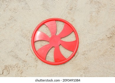 Red Frisbee Disk On Sand