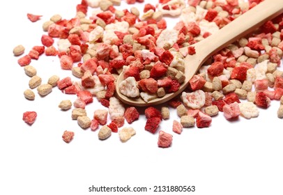 Red fruit, mix cornflakes with yogurt, oats and pieces dry strawberry in wooden spoon  isolated on white