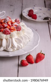  Red Fruit Pavlova With A Cup Of Tea On A Wooden Table