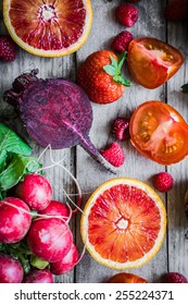 Red Fruits And Vegetables On Wooden Background