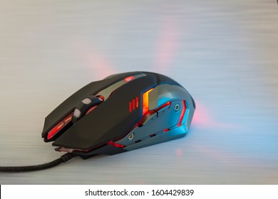 Red gaming mouse on silver texture desk