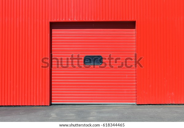 Red garage gate with small window on it.\
Large automatic up. Multicolor background\
set
