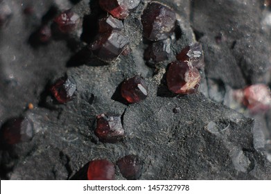Red garnet crystals still attached to their host rock, all natural setting.Almadine Garnets in their natural enviroment, capture taken underground in a goldmine.