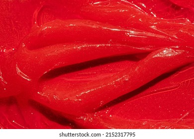 Red Gel Texture. Cosmetic Clear Liquid Cream Smudge. Skin Care Product Sample Closeup. Toothpaste Or Wax Background