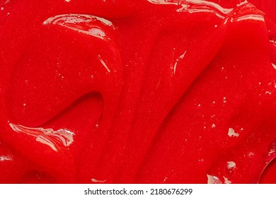 Red Gel Texture. Cosmetic Clear Liquid Cream Smudge. Skin Care Product Sample Closeup. Toothpaste Or Wax Background