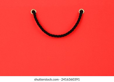 A red gift bag with black handles and a place for text.Black Friday sale. Creative background design concept in the form of a gift bag, banner for advertising or branding, poster template.Horizontally - Powered by Shutterstock