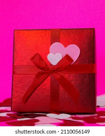 Red Gift Box With Hearts. Shiny Red Box With Felt Hearts. Pink Background. Good For Any Social Media Use Or Advertisement. 