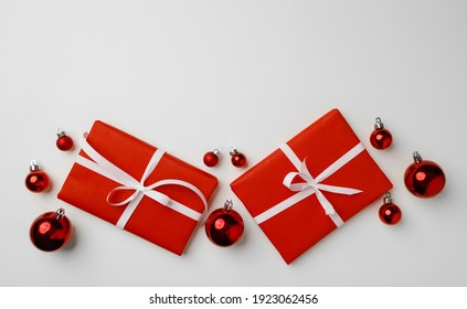 Red Gift Boxes And Christmas Baubles On White Background