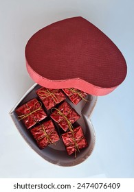 Red Gift Boxes Inside A Heart-Shaped Box