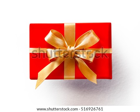 Red gift with golden bow on white background. Close up. Top view. High resolution product