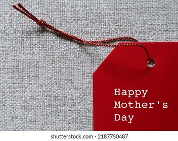 Red gift tag with text written Happy Mother's Day, refers to celebration honoring the mother or motherhood, to thank for all she's done and wish mom happiness