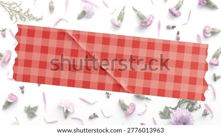 Red gingham check pattern washi tape strip isolated on a minimalist floral background with pink flowers. Aesthetic red and white plaid adhesive tape mockup over a delicate flat lay of carnation petals and green leaves.