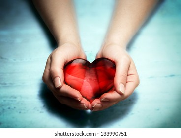 Red Glass Heart In Woman Hands