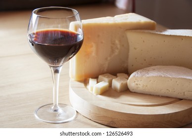 A Red Glass Of Wine And Italian Cheese