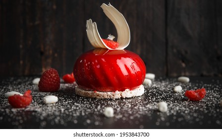 Red glazed cake decorated with white chocolate and raspberry - Powered by Shutterstock