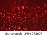 Red glitter bokeh background with sparkling light, abstract defocused texture. Holiday lights.