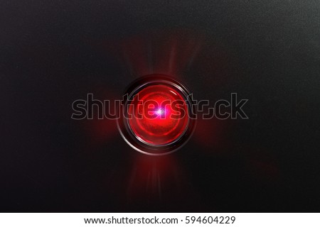 Red glowing status indicator, warning lamp or button, on black panel.