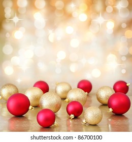 Red And Gold Christmas Baubles Ornaments On Background Of Defocused Golden Lights. Shallow DOF.