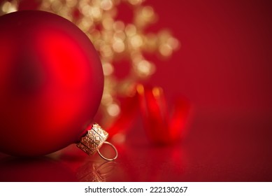 Red and golden christmas ornaments on red background with copy space. Xmas holiday theme. - Powered by Shutterstock