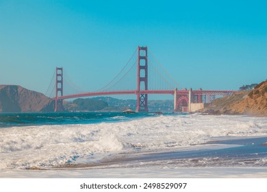 Red Golden Gate Bridge View From Baker Beach in San Francisco With Waves of the Ocean Waving and Spraying Water and Foam to the Shore of California - Powered by Shutterstock