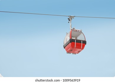 Red Gondola Car Lift On The Ski Resort Over Forest Trees