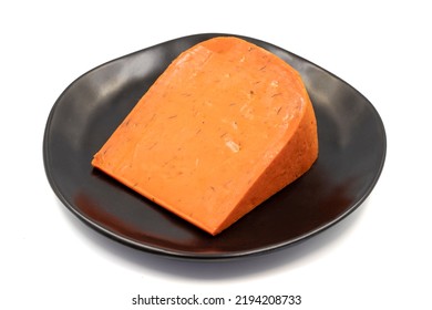 Red gouda cheese. Guoda cheese with sun-dried tomatoes and basil isolated on a white background. Dutch cheese. close up - Powered by Shutterstock