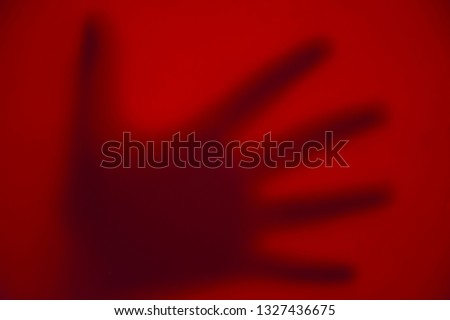 Red gradient background. Red texture. Monochrome background. Abstraction and minimalism. Hand on a red background. Red hand. Сток-фото © 
