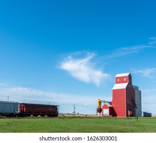 Red Grain Elevator and Grain Freight Train - Road trip through Saskatchewan, Central Canada