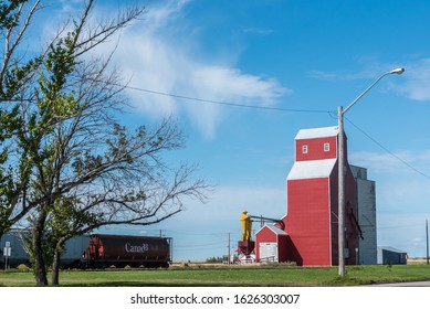 Red Grain Elevator and Grain Freight Train - Road trip through Saskatchewan, Central Canada
