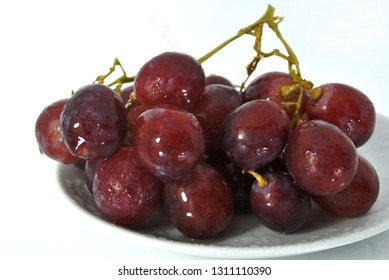 red grape on white plate and white scene