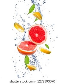 Red grapefruits and yellow lemons in a splash of water. Grapefruit and lemon in motion. Tropical fruit concept.