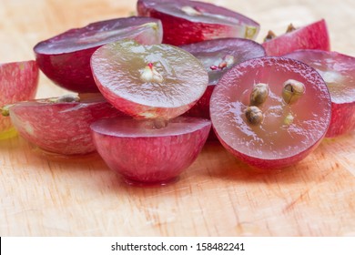 Red Grapes Cut In Half, Isolated On A White Background.