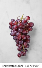 Red Grapes Isolated On A Marble Background Viewed From Above. Top View