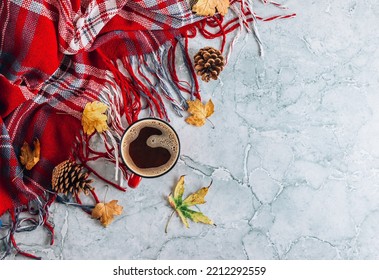 Red and gray autumn flat lay composition. Cup of coffee, plaid, pumpkin shaped candles, autumn leaves on gray marble background. - Shutterstock ID 2212292559