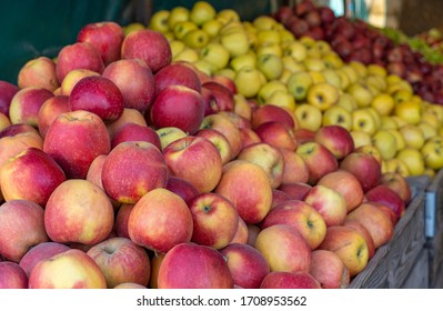 Red And Green Apples On The Market Counter. Apples In Wooden Boxes On The Grocery Shelf. Close Up.