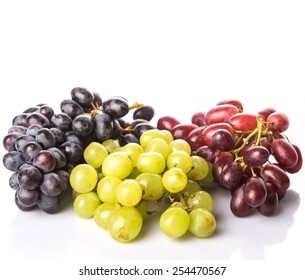 Red, Green And Black Grapes Fruits Over White Background