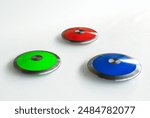 Red, green and blue color of athletics discus throw on an isolated white background